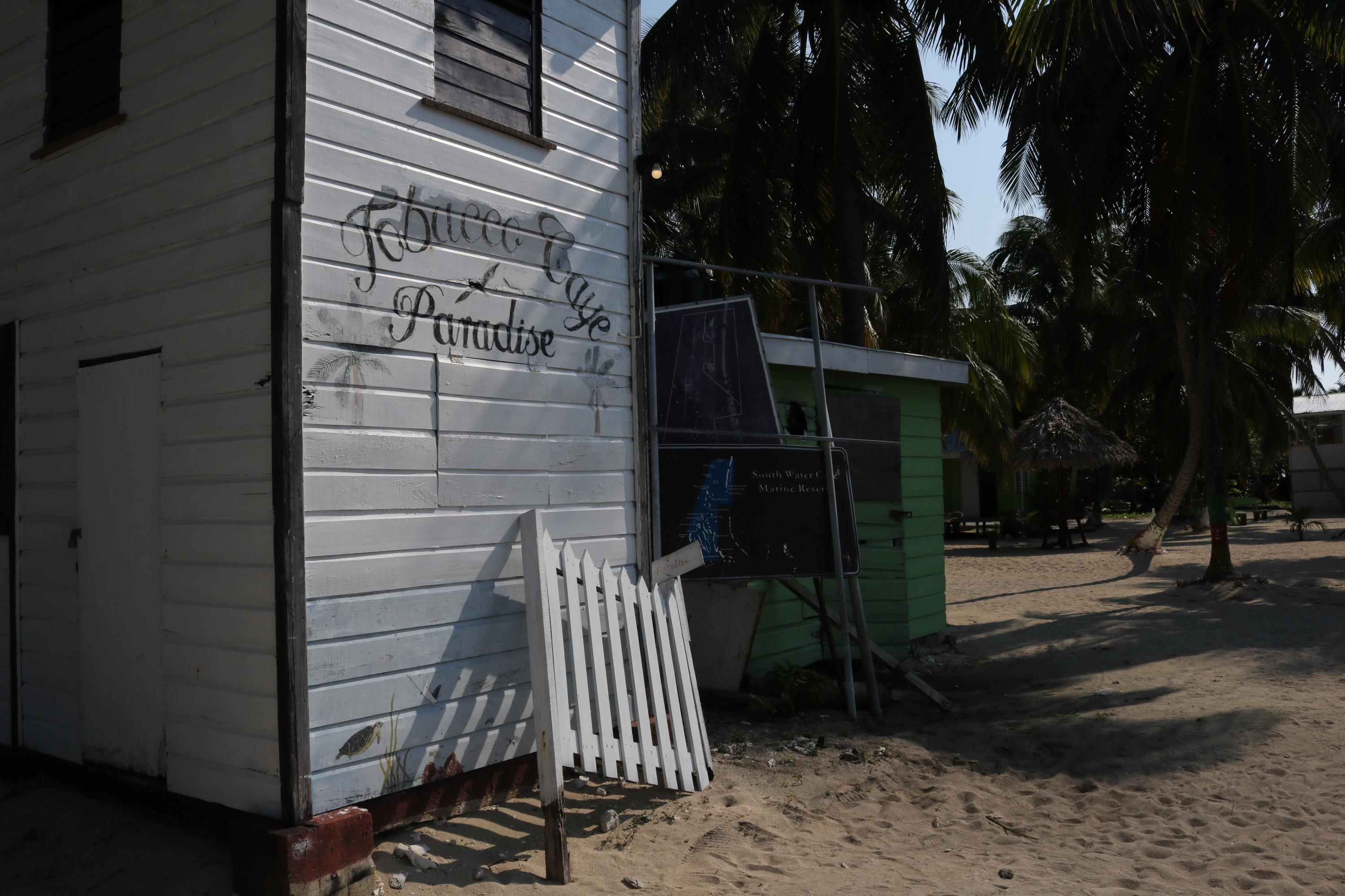 Sign on building welcoming visitors to the tobacco caye